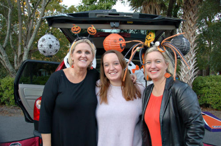 Three women doing trunk or treat