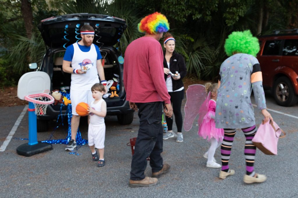 Foks in costumes giving out candy for Trunk or Treat